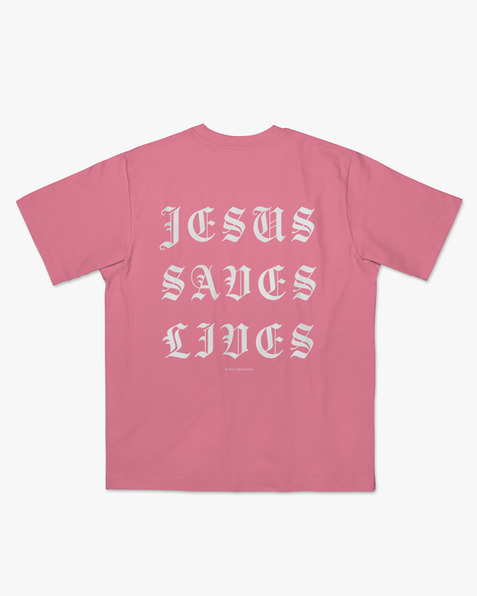 Pink t-shirt with 'Jesus Saves Lives' text on a white background